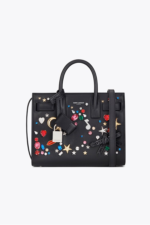 Crystals and brass embellished leather bag from Saint Laurent - Front Row
